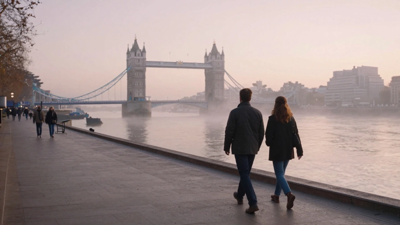 Two people walking peacefully along the Thames at sunrise, London skyline in the distance.